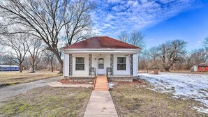 A single-story house with a front porch, a wooden walkway leading to the door, and a clear sky. - Historical West Mineral Escape w/ Porch! (West Mineral)