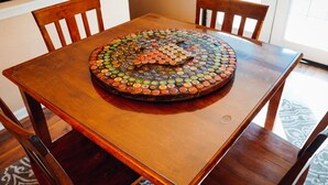 A wooden table with a circular arrangement of colorful bottle caps.