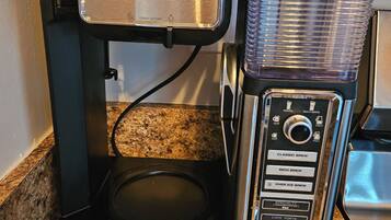 A Ninja coffee maker with a digital display, drip stop, and various brew settings.