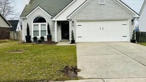 A single-story house with a garage, a front entrance, and a small front yard. - Escape to Comfort in Lexington/Hamburg: Stylish 3BR/2.5BA Home (Lexington)