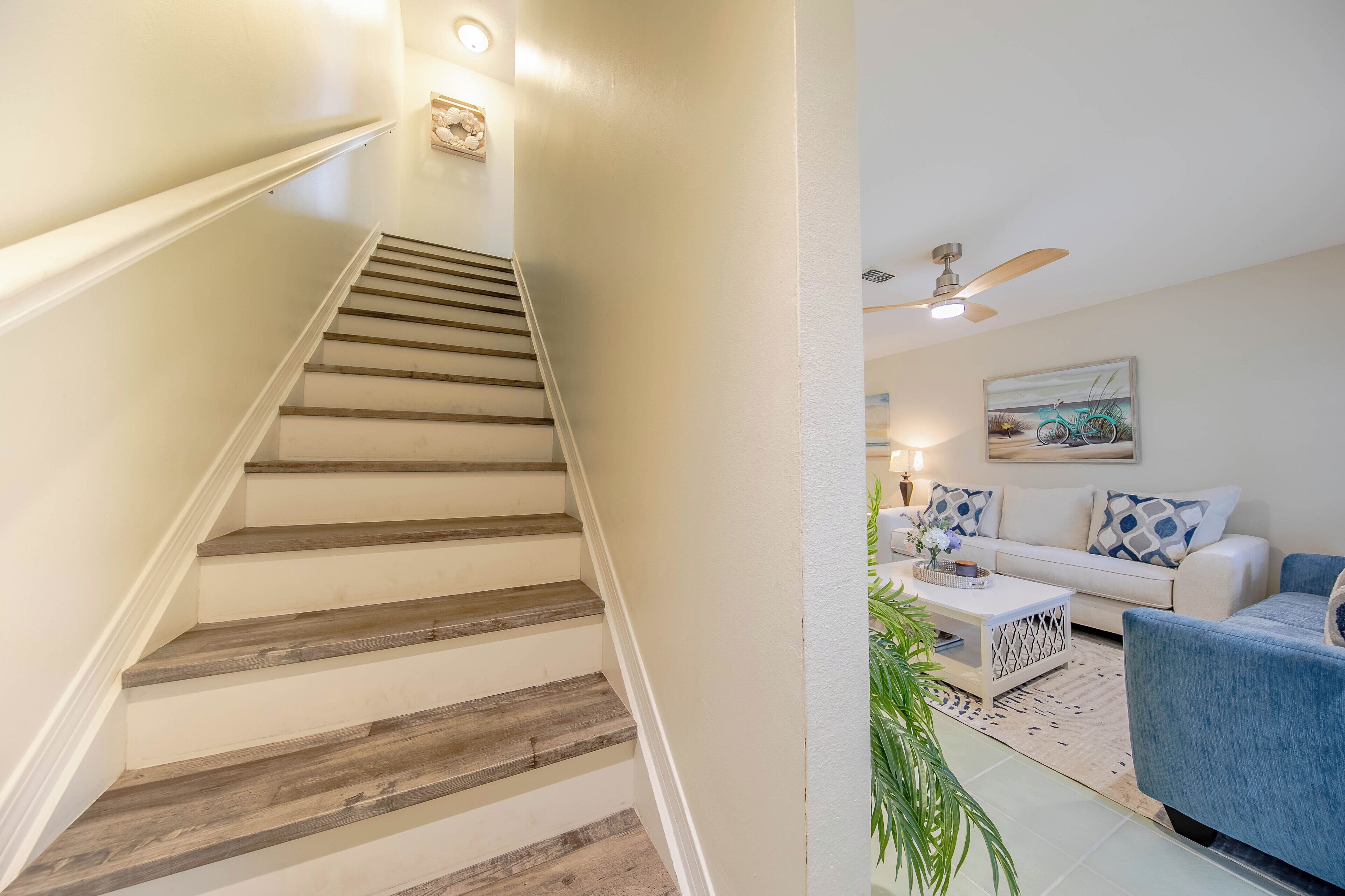 A staircase with wooden steps and a white wall.