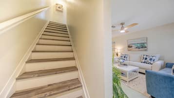A staircase with wooden steps and a white wall.