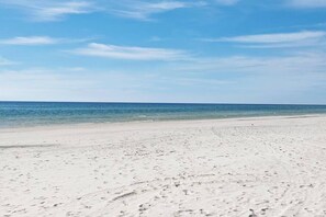 A wide sandy beach with footprints leading to the water. - Nirvana30A at Seagrove Beach, 30A 2 min walk to the beach - family friendly home (Santa Rosa Beach)