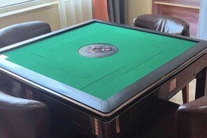 A pool table with a green felt surface and a circular center. - Nuoman Holiday Hotel (Xiantao)