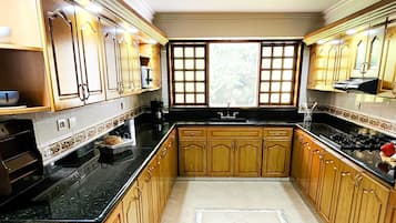 Villa | Private kitchen | Full-sized fridge, microwave, oven, blender