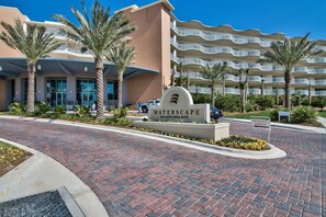 A hotel entrance with a sign reading "WATERSCAPE 1110 Santa Rosa Blvd." and a "MODEL OPEN" sign. - Stylish Top-Floor Waterscape Condo, Free Beach Service! (Fort Walton Beach)