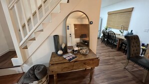 A staircase with a wooden finish, a dining area with a wooden table and chairs, and a bench. - Wow! Only 3 min to Gore Mtn! King bed too (North Creek)