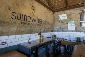 A kitchen with a rustic design, featuring a wall-mounted sign that reads 'Somewhere' and 'bocas del toro panama'. - Somewhere Bocas del Toro (Bocas del Toro)