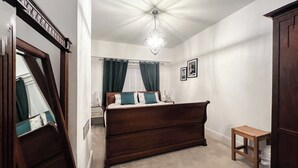 A bedroom with a large bed, a nightstand, a wooden chair, and a dresser. - 3 bedroom accommodation in Utley, near Haworth (Utley, near Haworth)