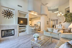 Relax in this stylish living area with a flat-screen TV, comfortable seating, and a dining space.