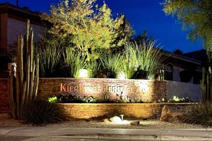 Enter a serene oasis with a beautifully landscaped garden featuring a variety of plants and cacti.