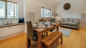Un salon moderne avec une table à manger en bois, un canapé et un banc.