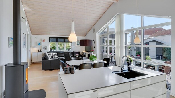 A modern kitchen with a central island, large windows, and a visible stove. - Awesome home in Broager (Broager)