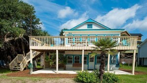 A two-story house with a balcony, a porch, and a staircase leading to the upper level. - Boogie Down! Classic Folly Vibe, Lower level unit. (Folly Beach)