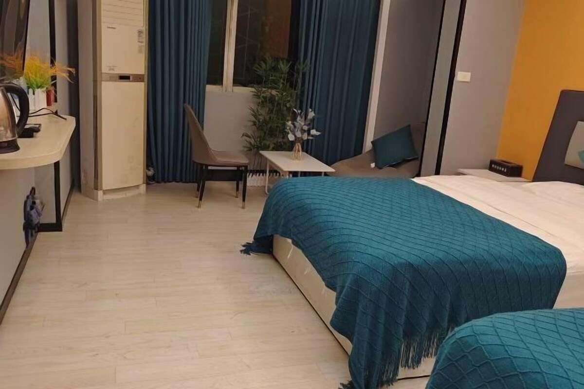 Ein Hotelzimmer mit einem Bett, einem Schreibtisch, einem Stuhl und einem kleinen Tisch.