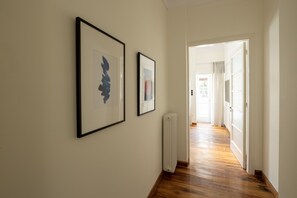 Enter a bright room with framed artworks and a large window.