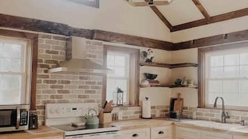 Fridge, microwave, coffee/tea maker, cookware/dishes/utensils