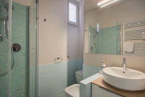 Shower, hair dryer, towels, toilet paper