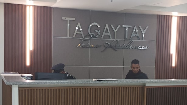 A reception desk with a sign reading "TAGAYTAY" and "The Residence". - Condo unit at Tagaytay Prime residences (Tagaytay)