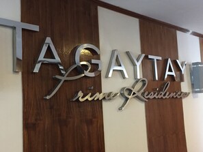 A wall with the words "TAGAYTAY" and "prime Residence" in metallic letters. - Condo unit at Tagaytay Prime residences (Tagaytay)