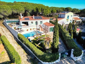 A residential property with a swimming pool, solar panels, and a well-maintained garden.