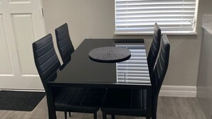A dining area with a rectangular table and six black chairs. - Looking in Orlando / Kissimmee great Location 2/1  (Kissimmee)