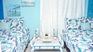 A bedroom with two beds, a bedside table with decorative items, and a view of a bridge through the window. - Miami Boho Beach Place - Great location for all your needs! (Hialeah)