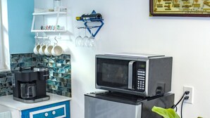 A kitchen with a stainless steel refrigerator, a microwave, and a coffee maker on the counter. - Miami Boho Beach Place - Great location for all your needs! (Hialeah)