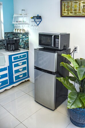 A kitchen with a stainless steel refrigerator, a microwave, and a coffee maker on the counter. - Miami Boho Beach Place - Great location for all your needs! (Hialeah)