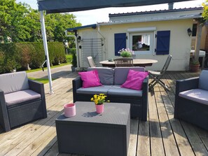 Relax on the patio with comfortable wicker furniture and a beautiful view.