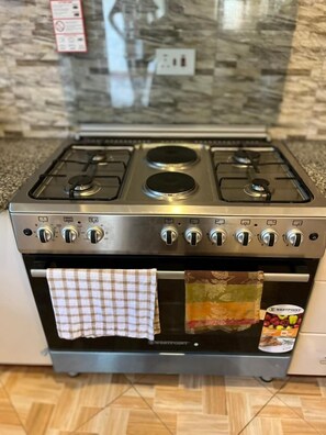 Full-size fridge, microwave, cleaning supplies