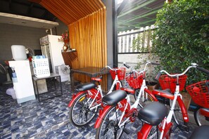 A covered outdoor seating area with a table, chairs, and a refrigerator. - The Seacret Kohlarn (Koh Lan)