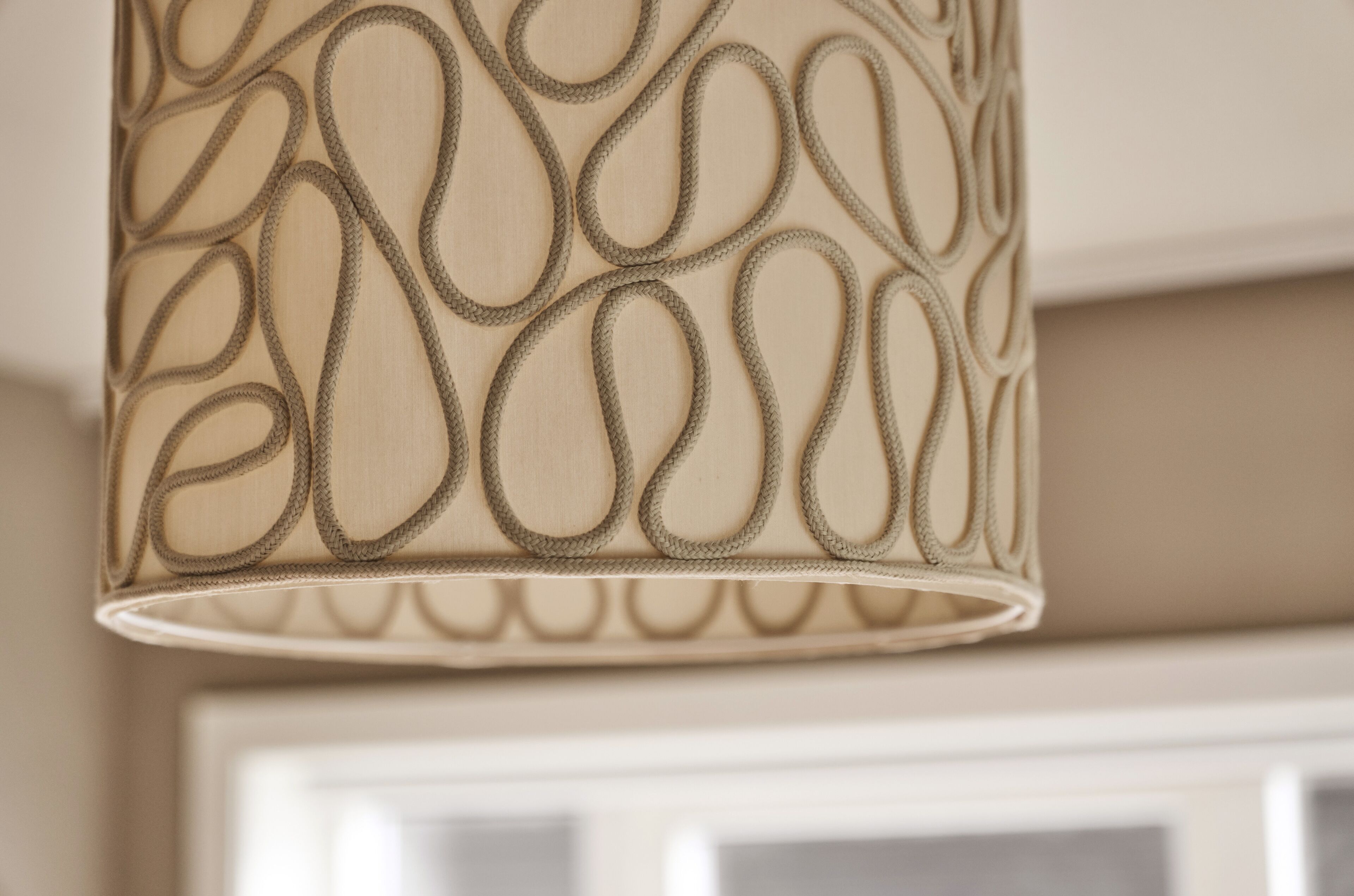 A close-up of a lamp with a woven design.