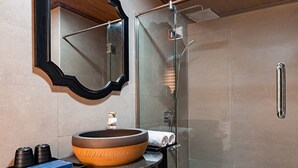 A modern bathroom with a large oval sink, a glass shower enclosure, and a metal towel rack. - La Pandora Boutique Cruise (Tuan Chau)