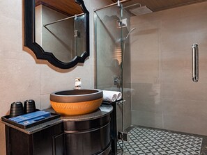 A modern bathroom with a large oval sink, a glass shower enclosure, and a metal towel rack. - La Pandora Boutique Cruise (Ha Long)