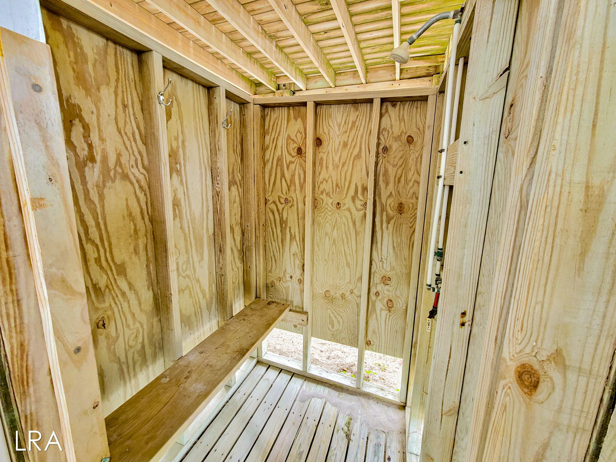 A wooden cabin with a built-in bench and a window.