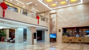 A spacious lobby with a reception desk, seating area, and a staircase leading to an upper level. - Zhongnan Hotel (Nan'an)