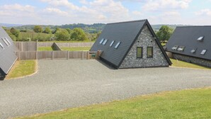 A residential area with houses featuring sloped roofs and multiple skylights. - Kerry Hill - The Sheepfold (Llandrindod Wells)