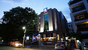 A modern building with a prominent sign, large windows, and a staircase leading to the entrance. - Zip By Spree Hotels Delhi Greater Kailash (New Delhi)