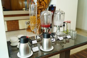 A coffee station with multiple coffee makers and a beverage dispenser. - Zip By Spree Hotels Delhi Greater Kailash (New Delhi)