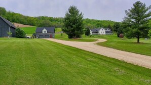 A rural landscape with a barn, a small house, and a large house with a porch. - Tamarack Point Homestead (Arcadia)