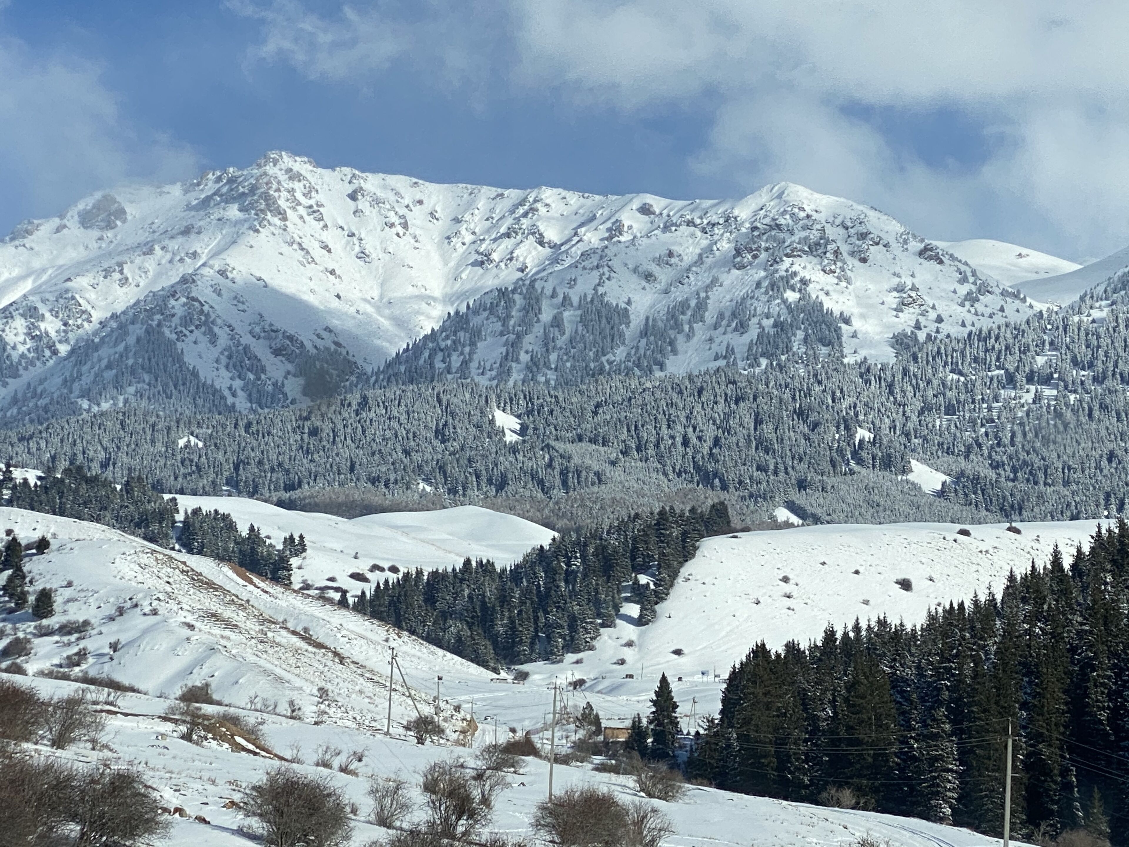 A snow-covered mountain landscape with a ski resort.