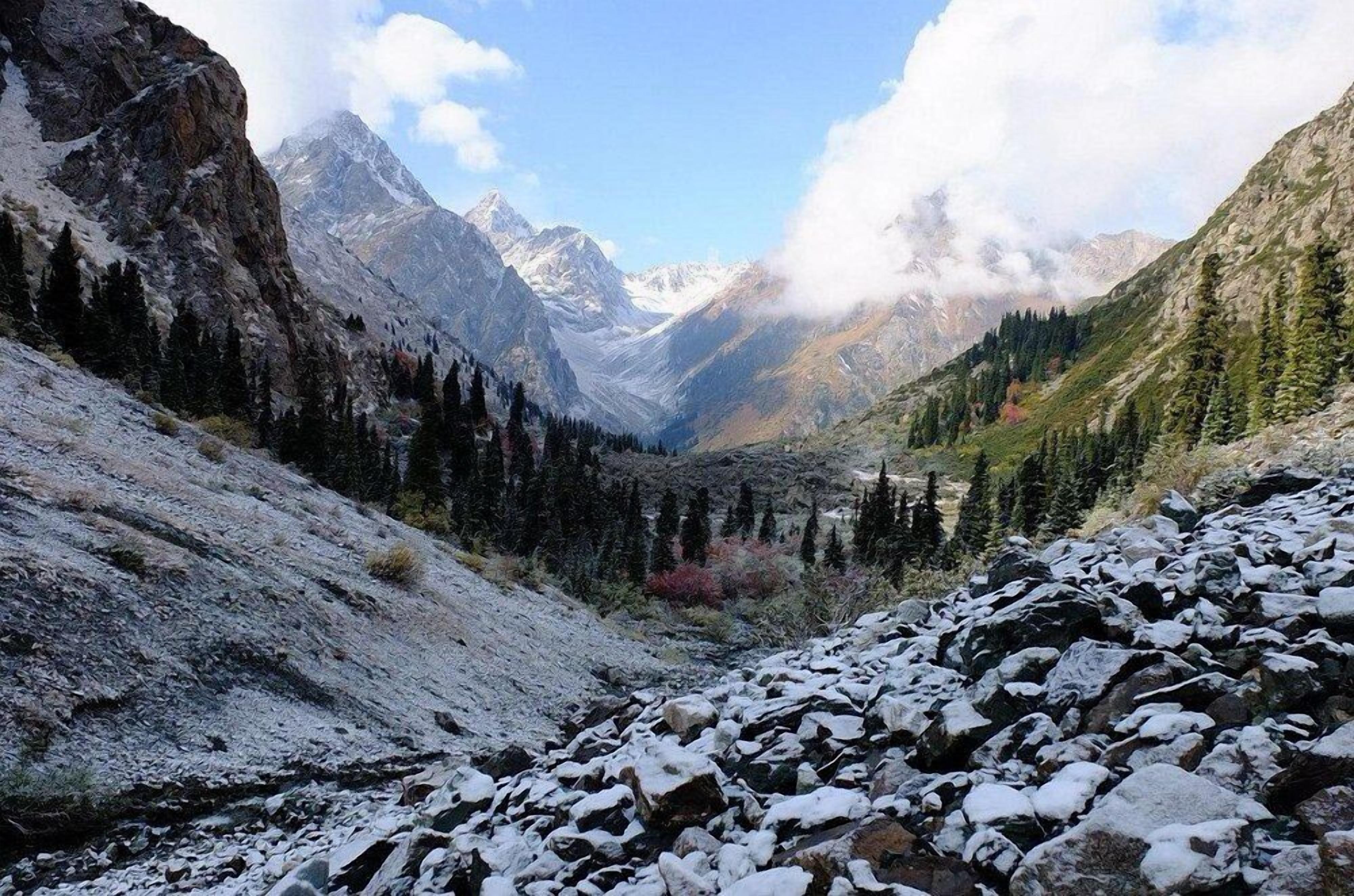 A mountainous landscape with rocky terrain and snow-covered ground.