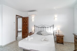 Cozy retreat with a comfortable bed, nightstand, and dresser.