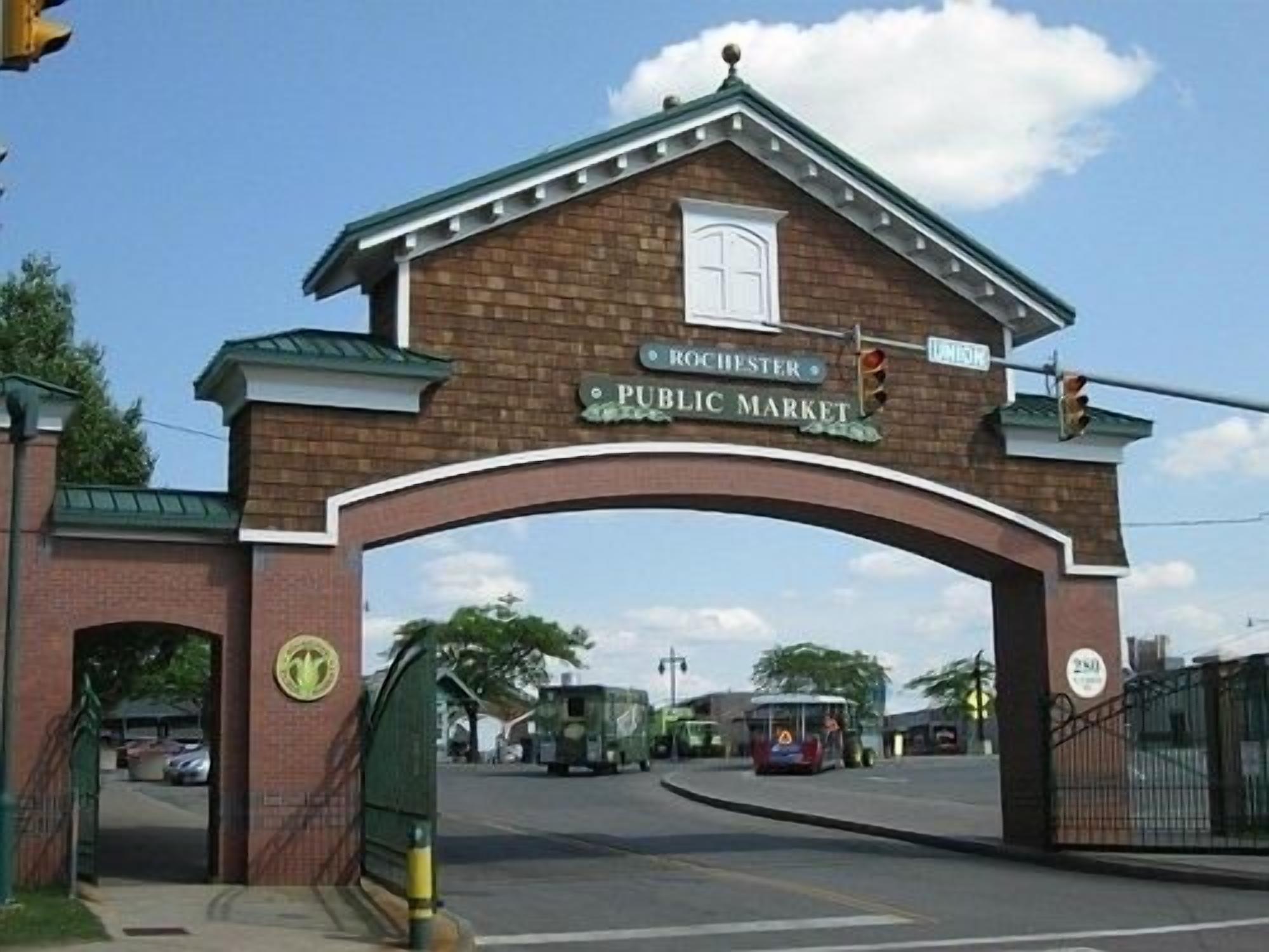 A brick archway with a sign reading "Rochester Public Market" above it.