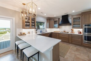 Fridge, stovetop, cookware/dishes/utensils, ice maker - Hobbs Realty - “Shore To Please” | Luxury Oceanfront w/ Saltwater Pool, Hot Tub & Elevator (Holden Beach)