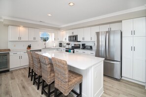 Fridge, paper towels, dining tables - Hobbs Realty - Enjoy stunning views from "Southern Heritage," a beautiful oceanfront home. (Holden Beach)