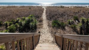 A wooden boardwalk leading to a beach with sparse vegetation and a clear view of the ocean. - Hobbs Realty - Oceanfront Dog Friendly w/Private Pool & EV Charger (Holden Beach)