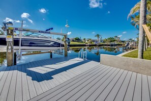 Enjoy waterfront views from the marina, surrounded by palm trees and residential buildings.