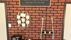A wooden dresser with drawers, a coffee maker, a coffee pot, and a sign on a brick wall. - City Escape: Cozy 2 bedroom Chalet in Jim Thorpe (Jim Thorpe)